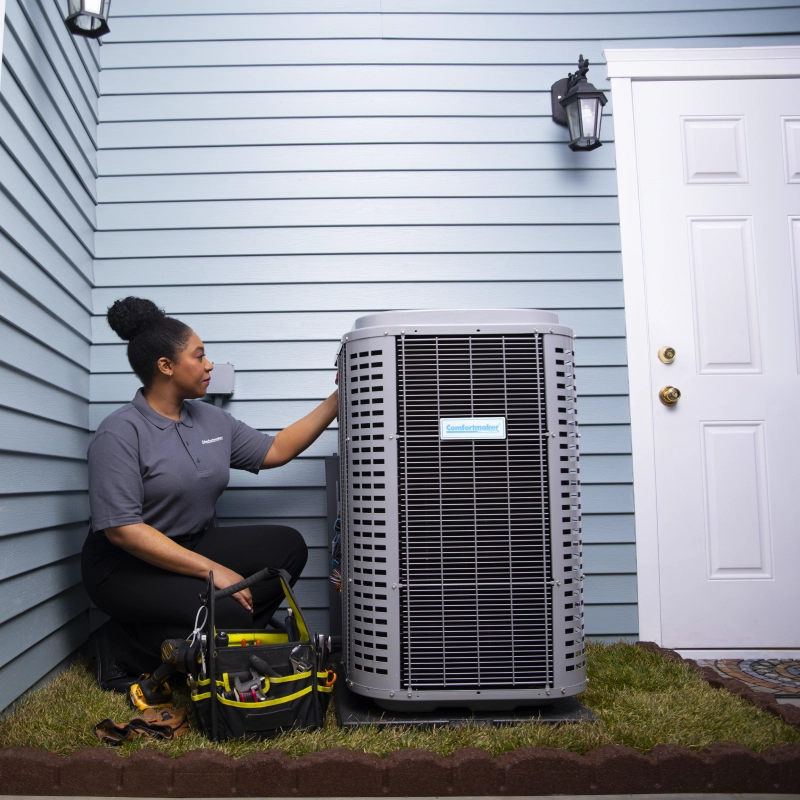 hvac tech working on unit