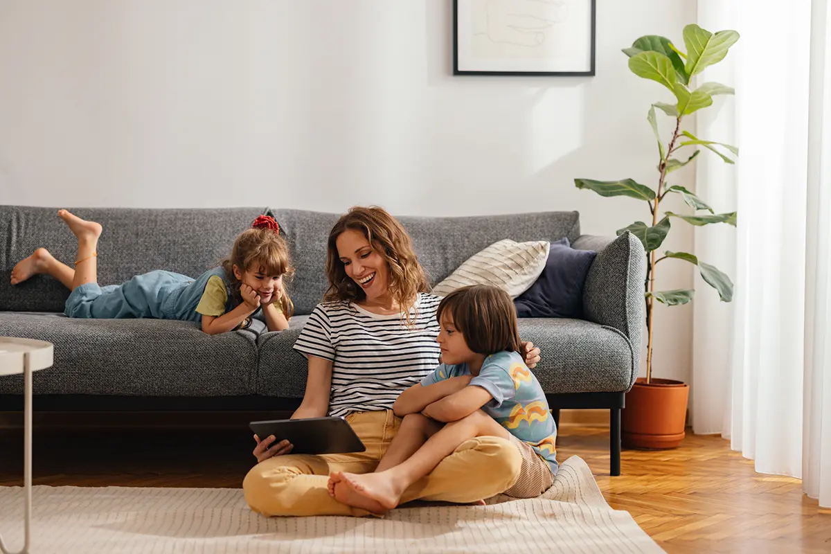 family sitting around tablet in living room
